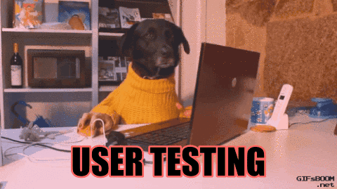 一隻黑狗在操作電腦，並且搖筆，字幕寫著 USER TESTING